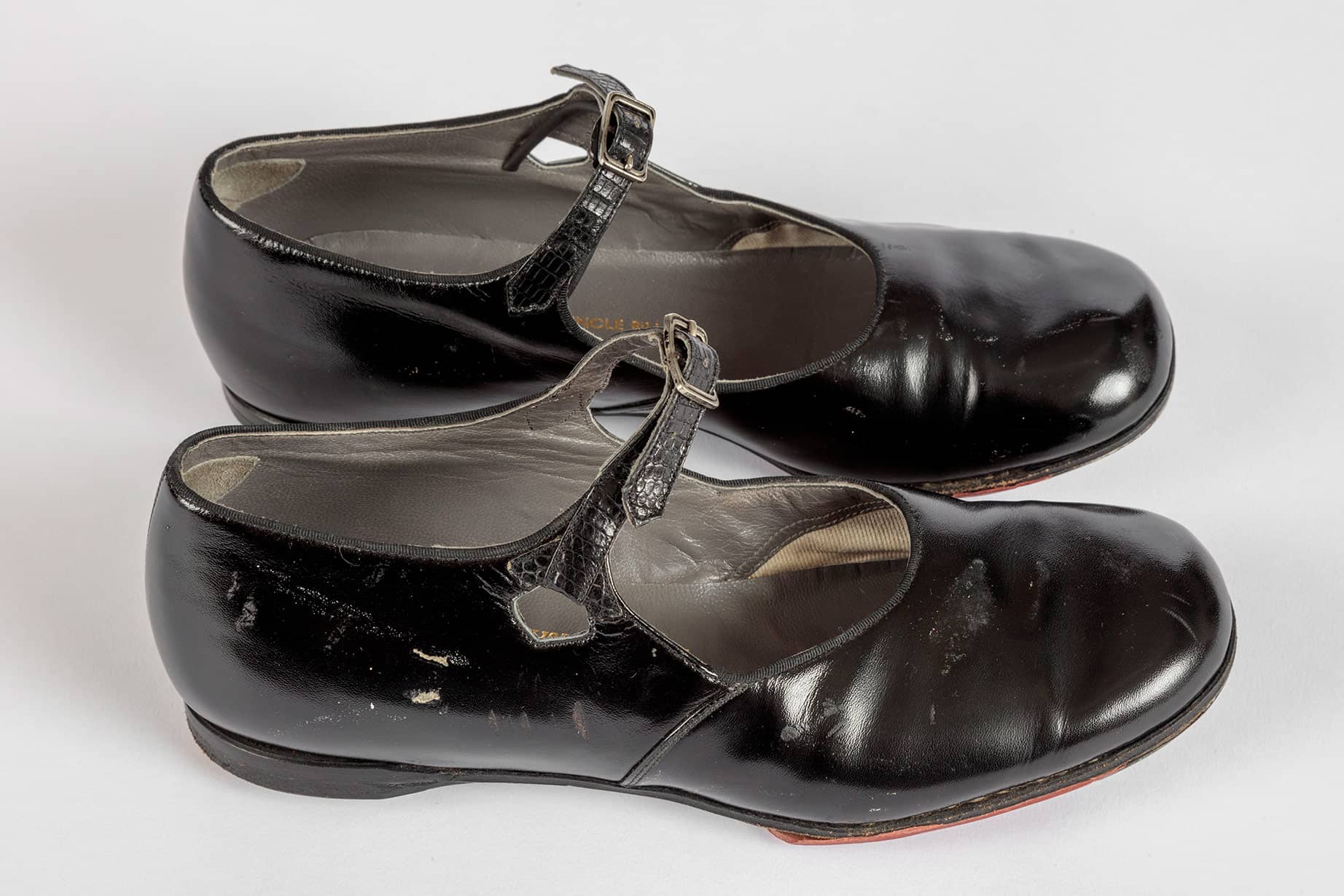 Shirley Temple's tap shoes and practice steps used during filming of <i>The Little Colonel</i> (1935). Academy Museum of Motion Pictures, Gift of Shirley Temple Black and Family. Photo by Joshua White, JWPictures/©Academy Museum Foundation