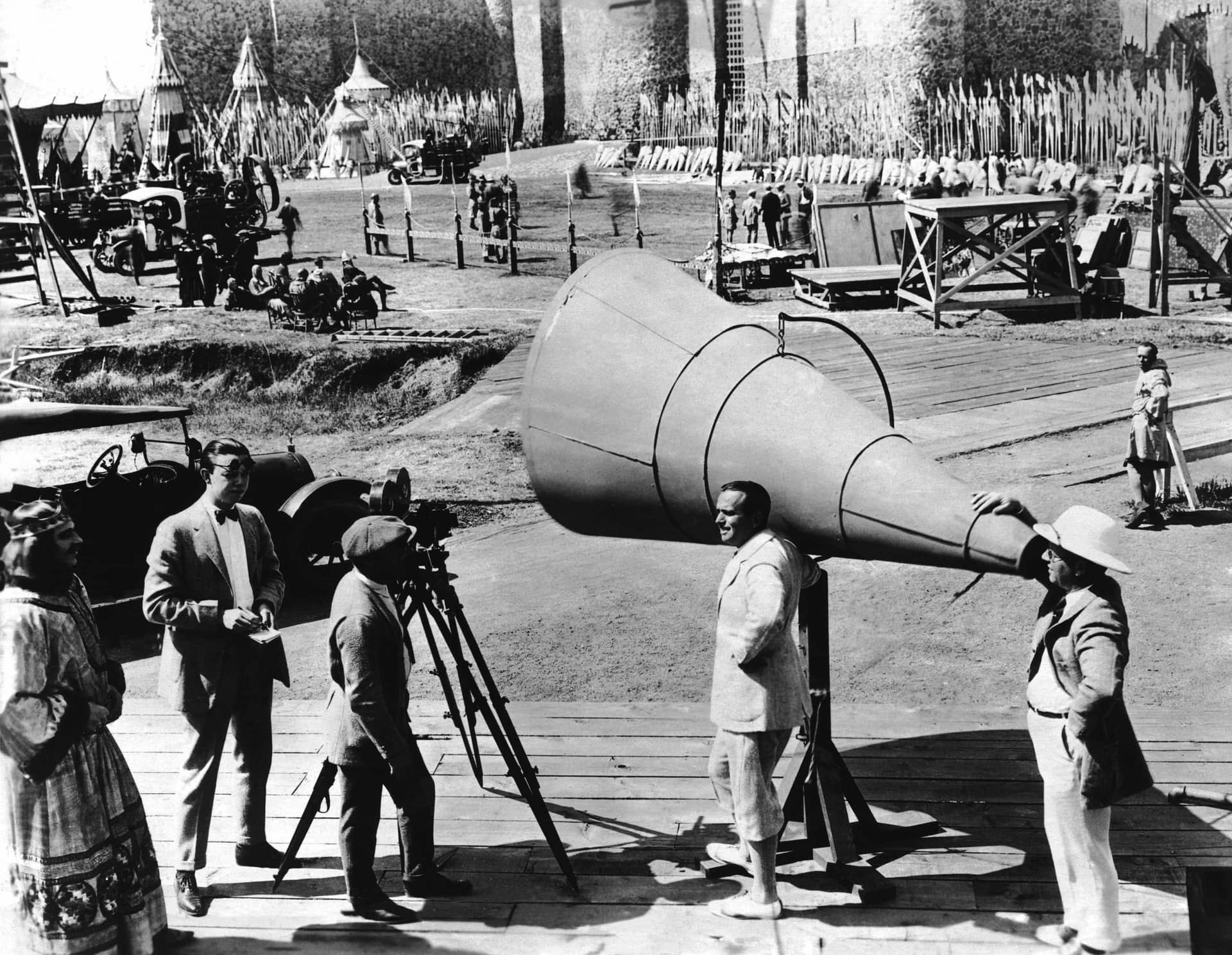 Director Alan Dwan (with raised sunglasses), cinematographer Arthur Edeson (in cap), and Douglas Fairbanks, Sr. (center) on-set of Robin Hood in 1923, Everett Collection.