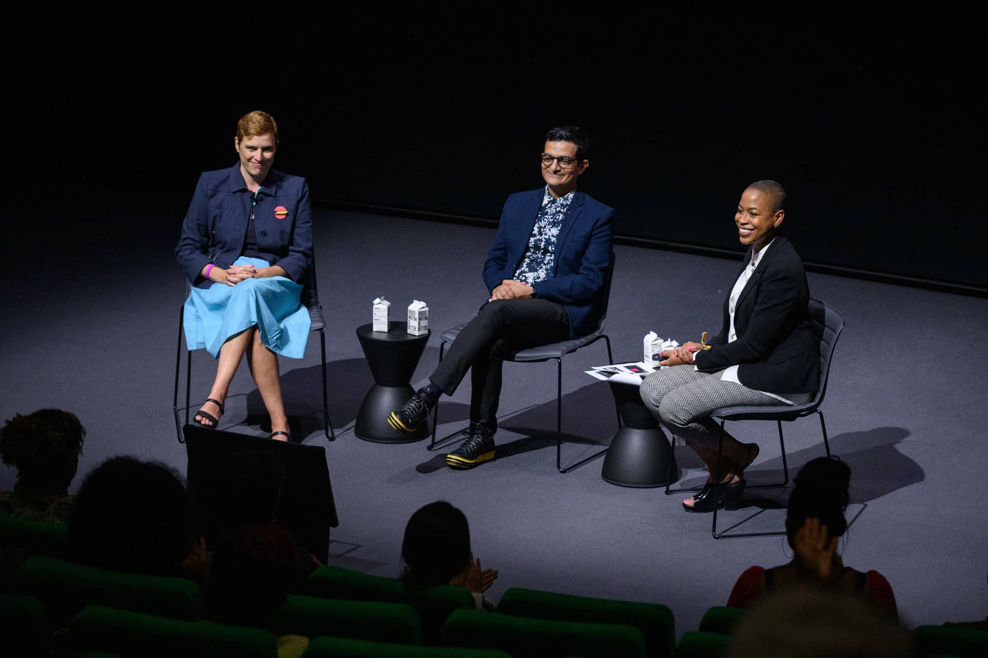 Picture of three individuals on stage in the Ted Mann Theater