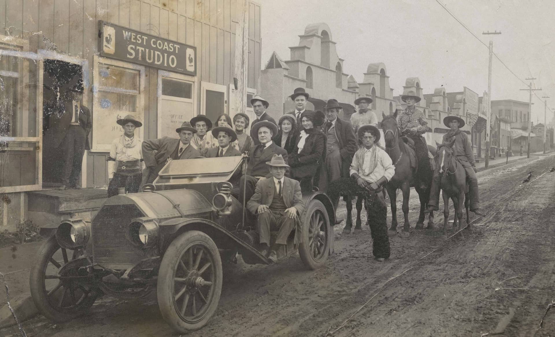 A group portrait of players, crew, and executives in front of Pathé Studios on Allesandro Street (now Glendale Boulevard) in the Edendale, Los Angeles, neighborhood, courtesy of Margaret Herrick Library, Academy of Motion Picture Arts and Sciences.