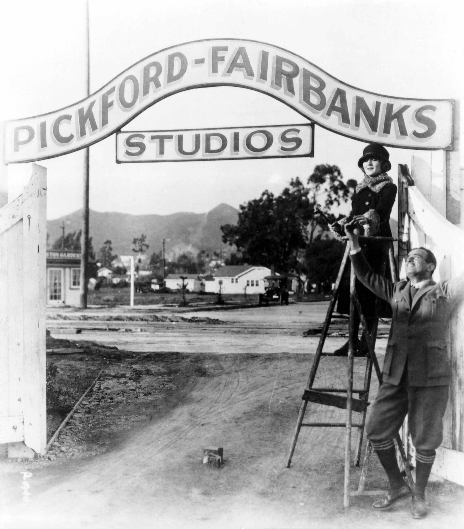 Mary Pickford and Douglas Fairbanks posing for a publicity shot in front of their new studio in 1922, Everett Collection