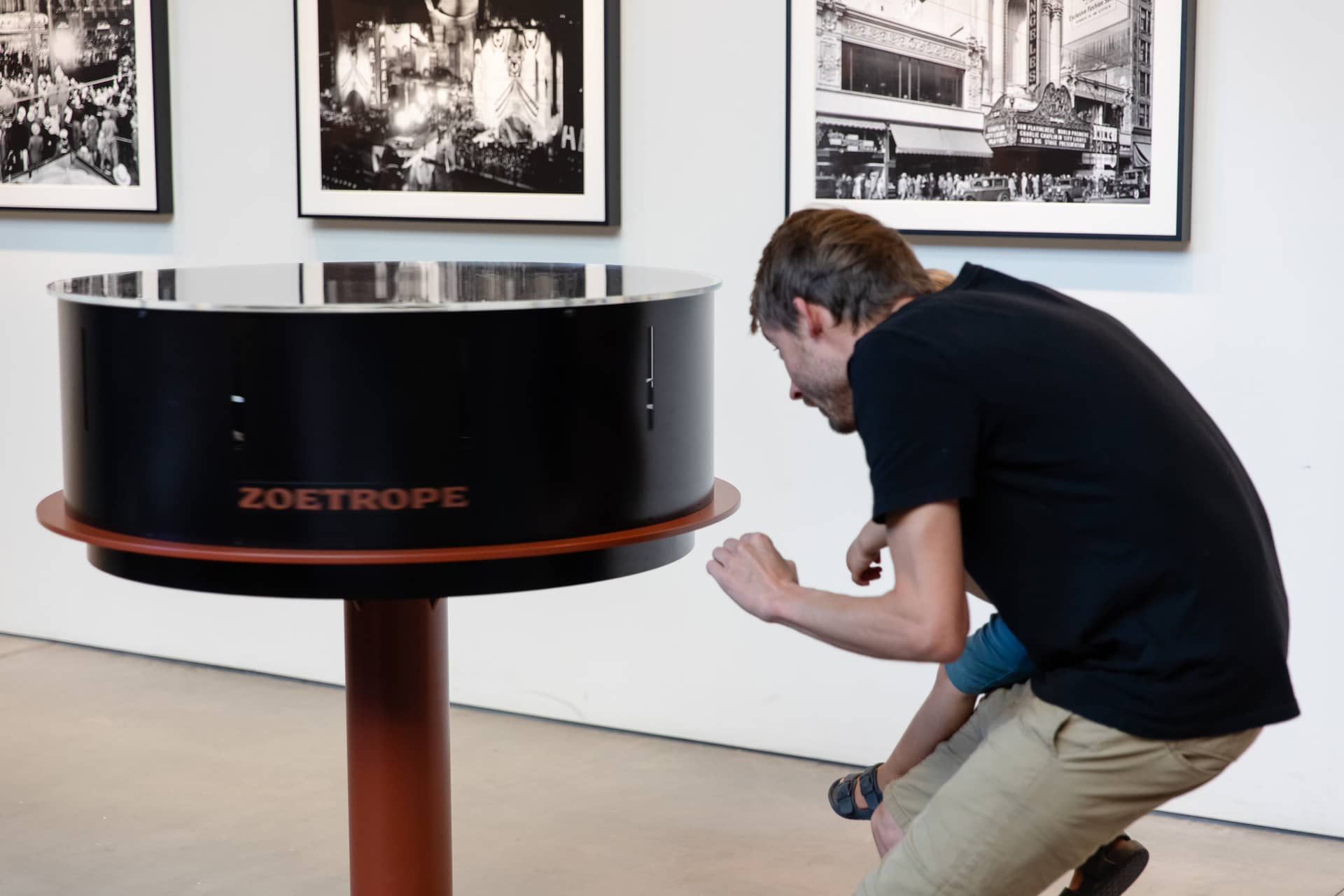 Man and child looking through Zoetrope