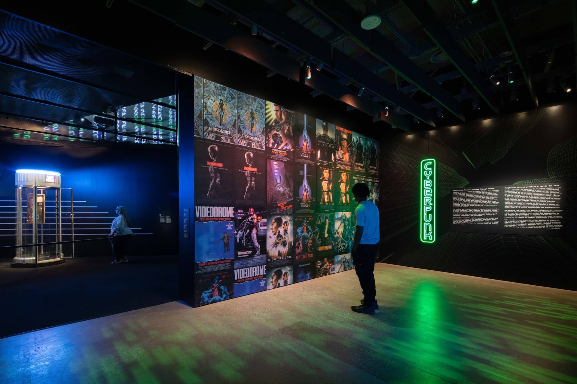 Man looking at posters on a wall in the cyberpunk gallery in the Academy Museum of Motion Pictures