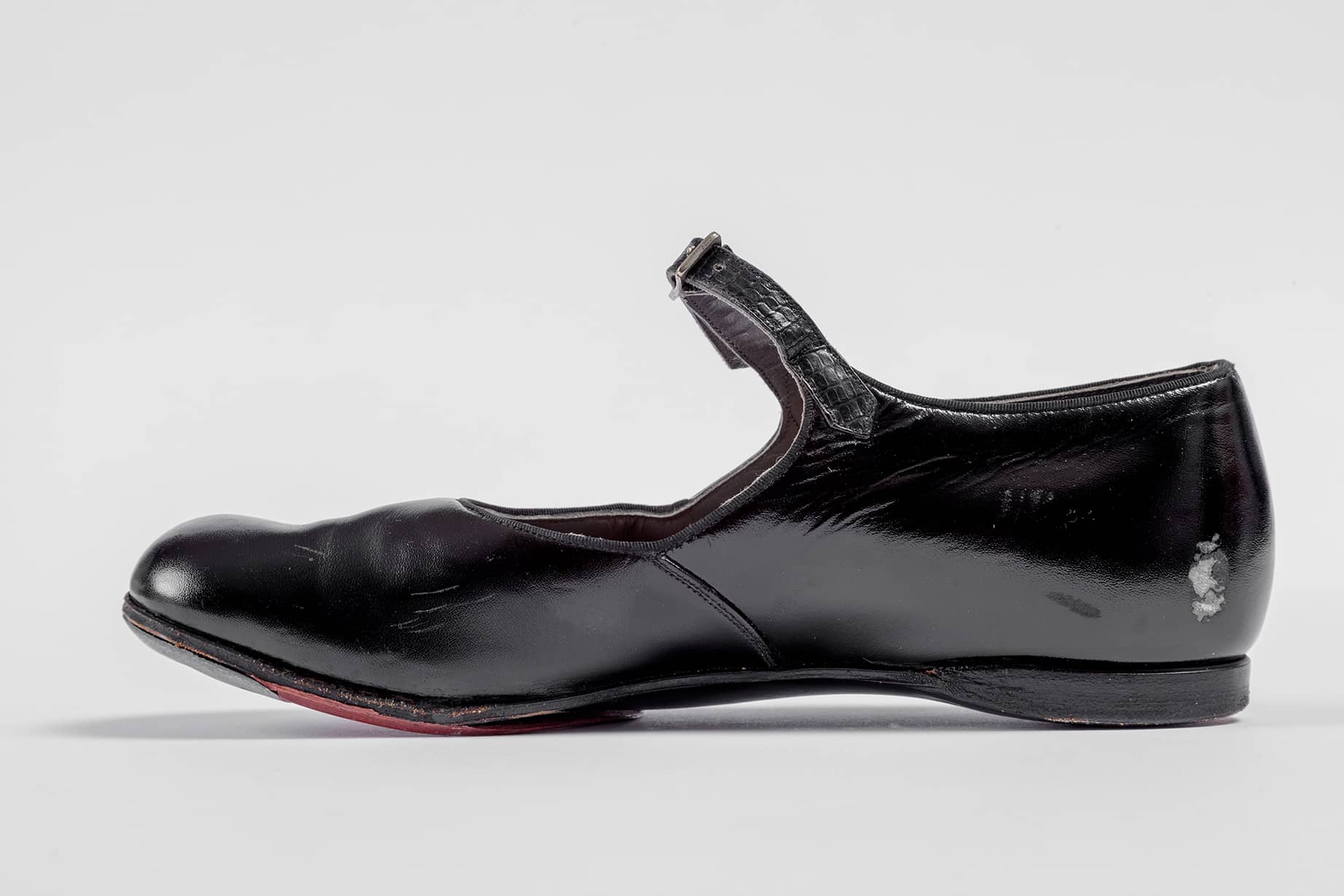 Shirley Temple's tap shoes and practice steps used during filming of <i>The Little Colonel</i> (1935). Academy Museum of Motion Pictures, Gift of Shirley Temple Black and Family. Photo by Joshua White, JWPictures/©Academy Museum Foundation