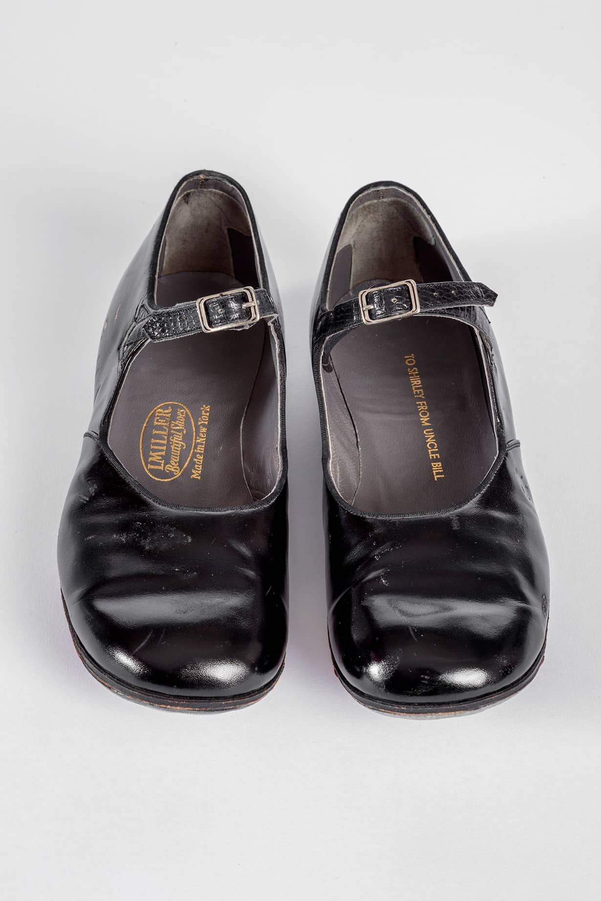 Shirley Temple's tap shoes and practice steps used during filming of <i>The Little Colonel</i> (1935). Academy Museum of Motion Pictures, Gift of Shirley Temple Black and Family. Photo by Joshua White, JWPictures/©Academy Museum Foundation