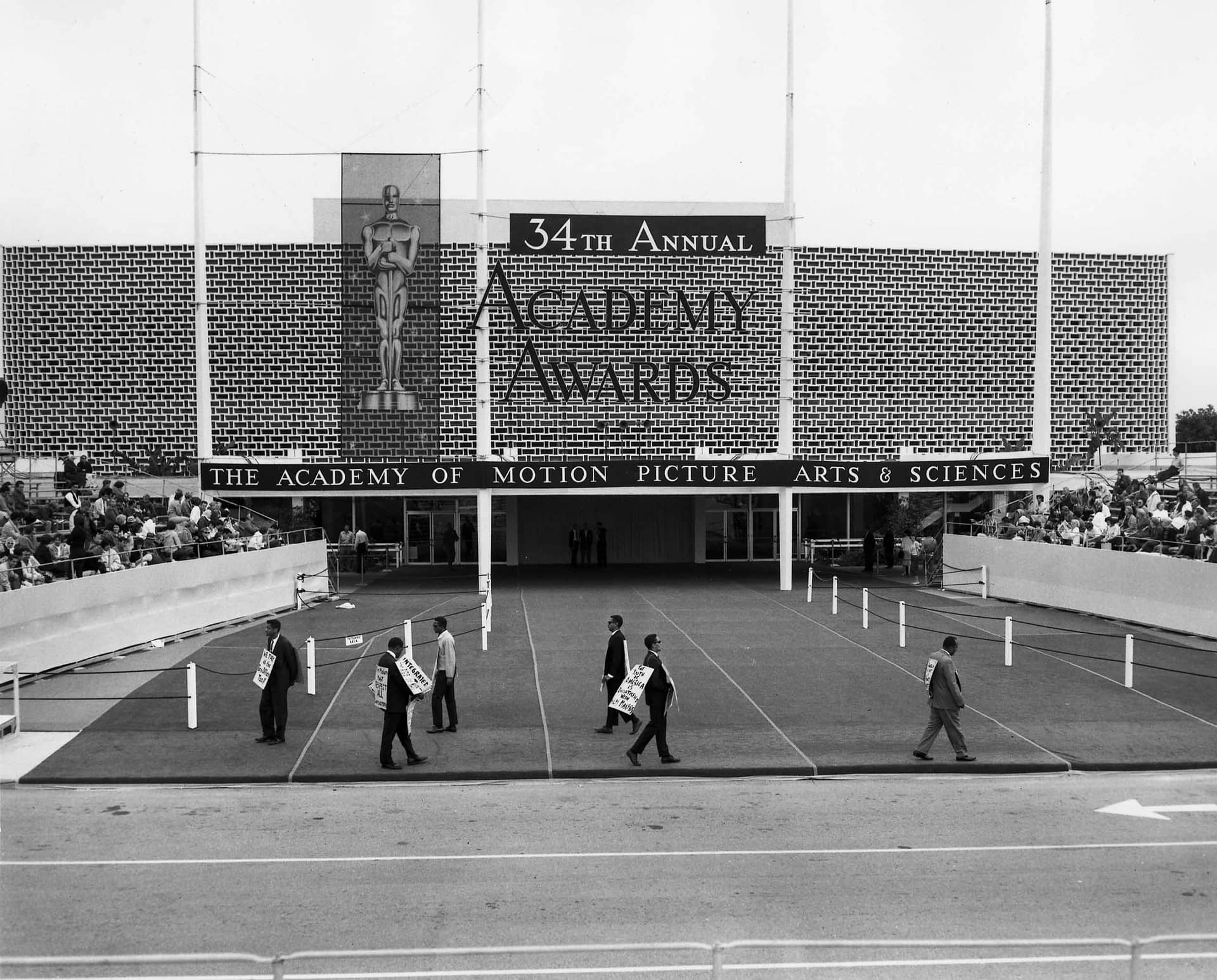 African American protesters picket outside the Santa Monica Civic Auditorium at the site of the 1963 Academy Awards ceremony with placards reading, “We pay at the box office too,” “Filmmakers must respect all consumers,” and “The youth of America is dissatisfied with filmmakers.”
Courtesy of Academy Awards show photographs, Margaret Herrick Library, Academy of Motion Picture Arts and Sciences